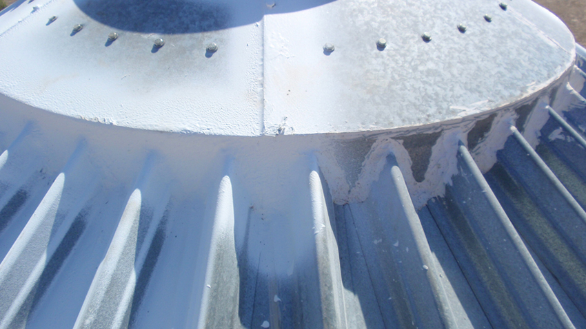 Step 3: Sealing the top inload hatch flashing using Glo-Mastic membrane.