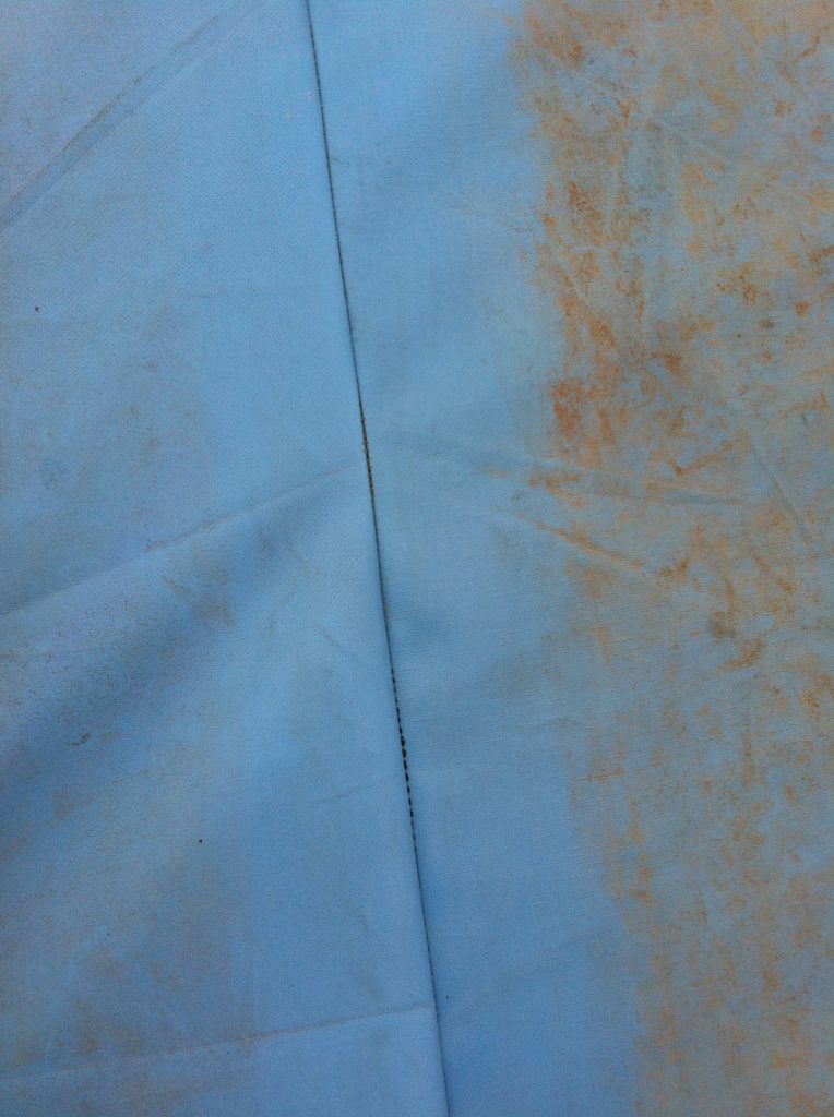 Step 1: Sewn PPE tarpaulin seam with exposed silicone wiped clean with water and prepared for sealing with G